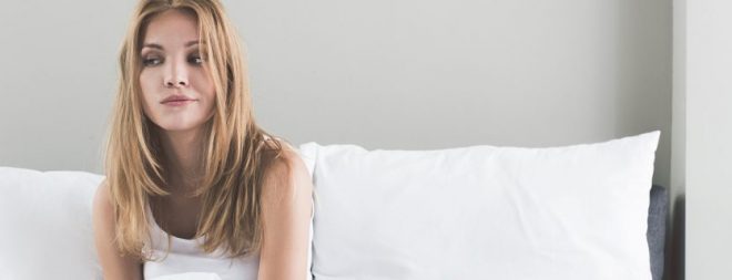 Frau auf dem Bett unglücklich und beziehungsunfähig